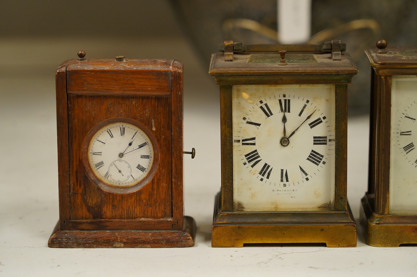 Two carriage clock, an Edwardian mantel clock, 25cm high, and a watch mounted in an oak case (4). Condition - fair, not tested for working